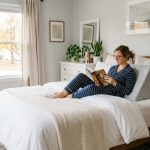 Person resting in bed supported by a wedge pillow to relieve back pain.